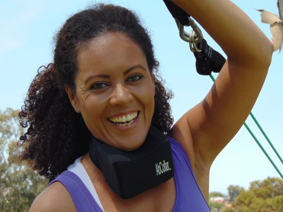 Woman in Purple Shirt Smiling, Holding Rope.