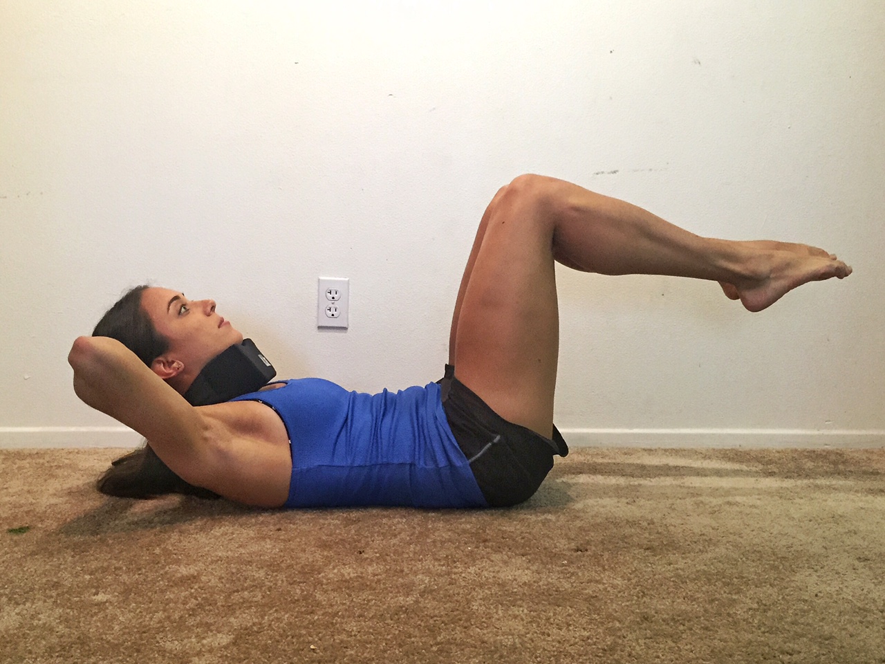 A Woman Stretches Her Legs on the Floor